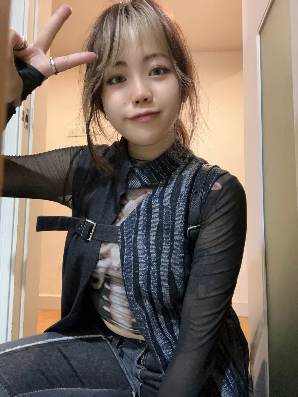 ブルー系のデニムジャケット、ブラック系のバッグ、グレー系のパンツを着用したレディースの秋コーディネートの4枚目の写真