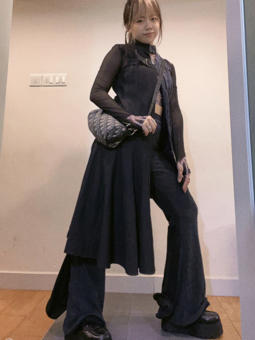 ブルー系のデニムジャケット、ブラック系のバッグ、グレー系のパンツを着用したレディースの秋コーディネートの3枚目の写真