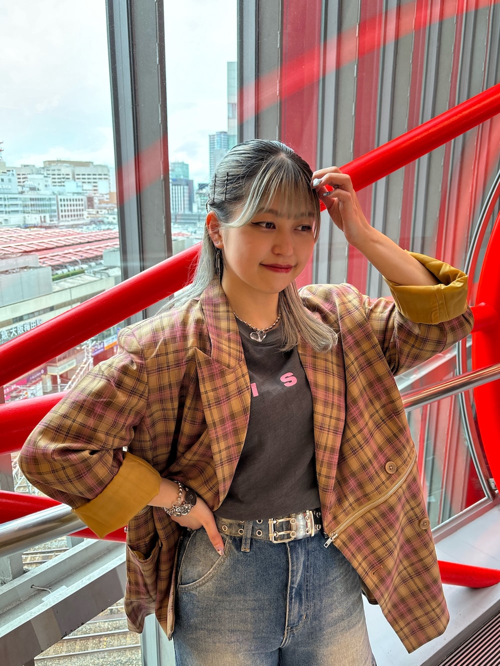 ブルー系のデニムパンツ、ブラック系のドレスシューズ、ブラウン系のテーラードジャケットを着用したレディースの夏コーディネートの4枚目の写真