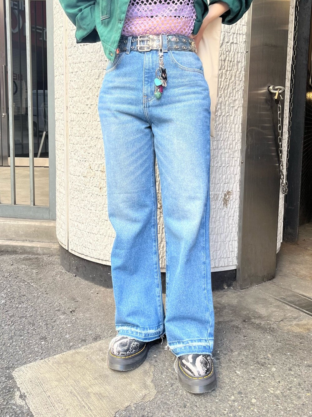ホワイト系のハンドバッグ、グリーン系のワンピース、ブルー系のデニムパンツを着用したレディースの夏コーディネートの7枚目の写真