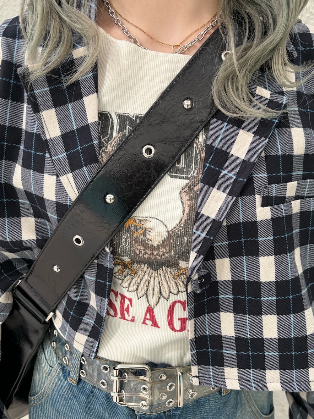 ブルー系のデニムパンツ、ブラック系のショルダーバッグ、ホワイト系のTシャツ/カットソーを着用したレディースの冬コーディネートの7枚目の写真