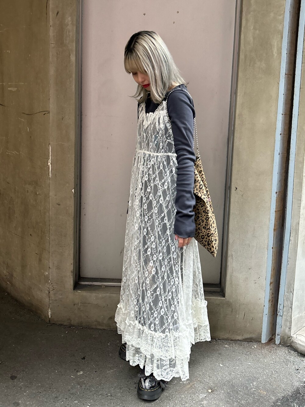 ホワイト系のワンピース、ブラック系のデニムパンツ、その他のトートバッグを着用したレディースの春コーディネートの4枚目の写真