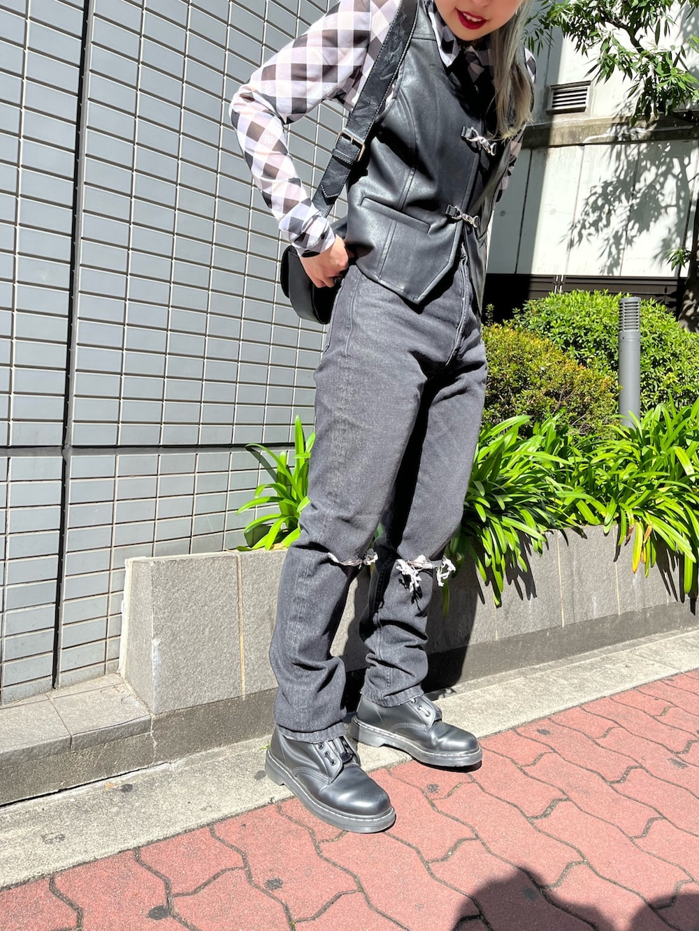 ブラック系のベスト、ブラック系のデニムパンツ、ブラック系のシャツ/ブラウスを着用したレディースの春コーディネートの8枚目の写真