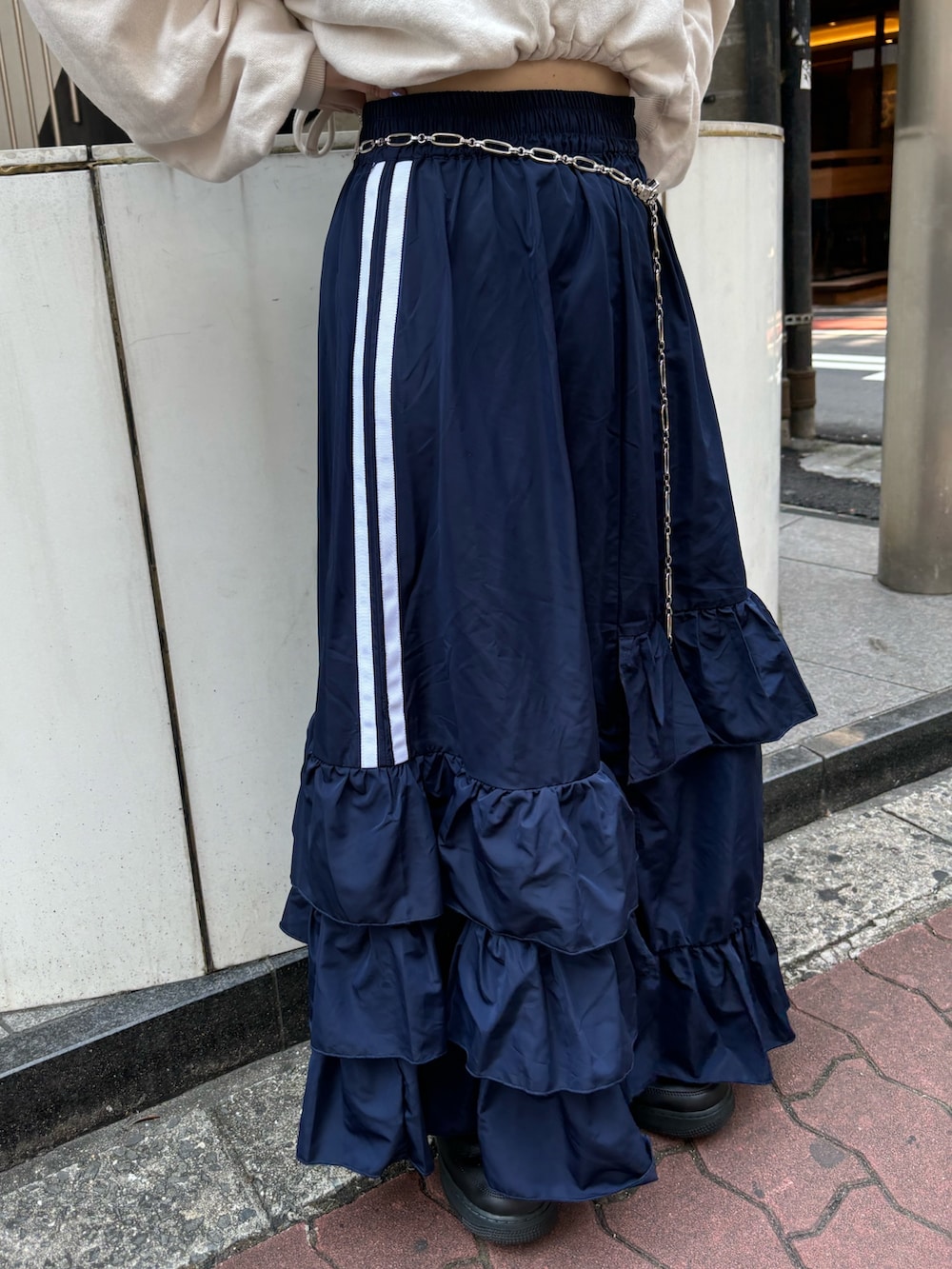 ブルー系のスカート、ホワイト系のスウェット、シルバー系のベルトを着用したレディースの夏コーディネートの8枚目の写真