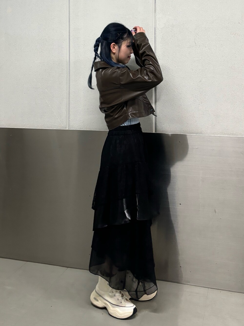 ブラック系のスカート、ホワイト系のスニーカー、ブルー系のTシャツ/カットソーを着用したレディースの冬コーディネートの2枚目の写真