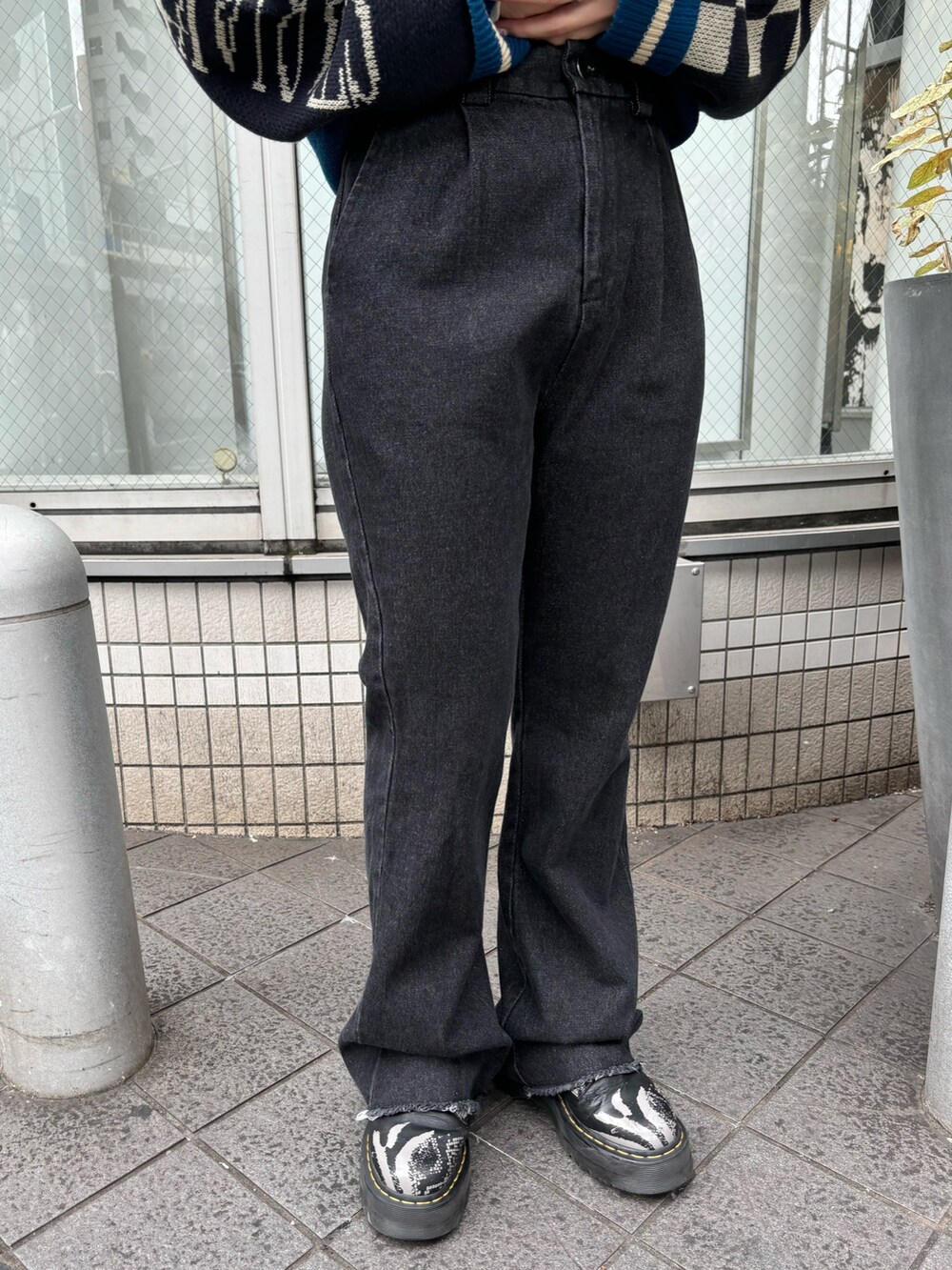 ブラック系のニット/セーター、ホワイト系のTシャツ/カットソー、ブラック系のその他パンツを着用したレディースの秋コーディネートの7枚目の写真