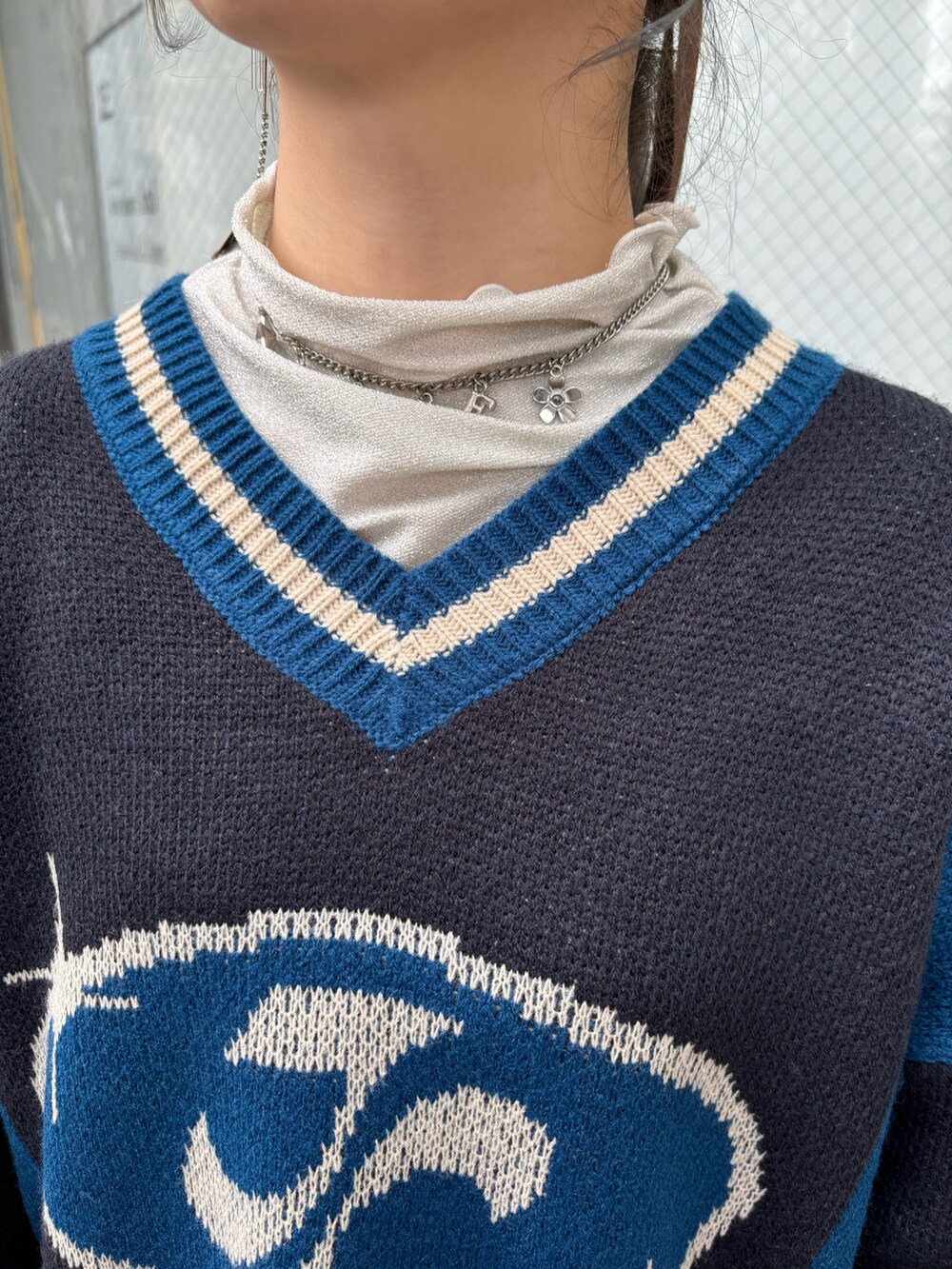 ブラック系のニット/セーター、ホワイト系のTシャツ/カットソー、ブラック系のその他パンツを着用したレディースの秋コーディネートの6枚目の写真