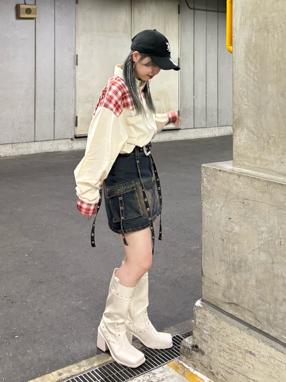 ブルー系のスカート、ホワイト系のシャツ/ブラウス、ホワイト系のブーツを着用したレディースの春コーディネートの2枚目の写真