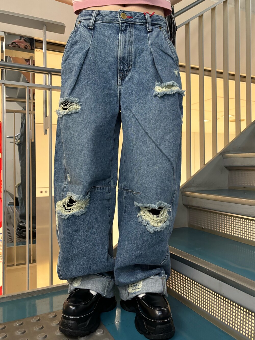 ブラック系のトートバッグ、ブルー系のデニムパンツ、ブルー系のデニムパンツを着用したレディースの春コーディネートの6枚目の写真