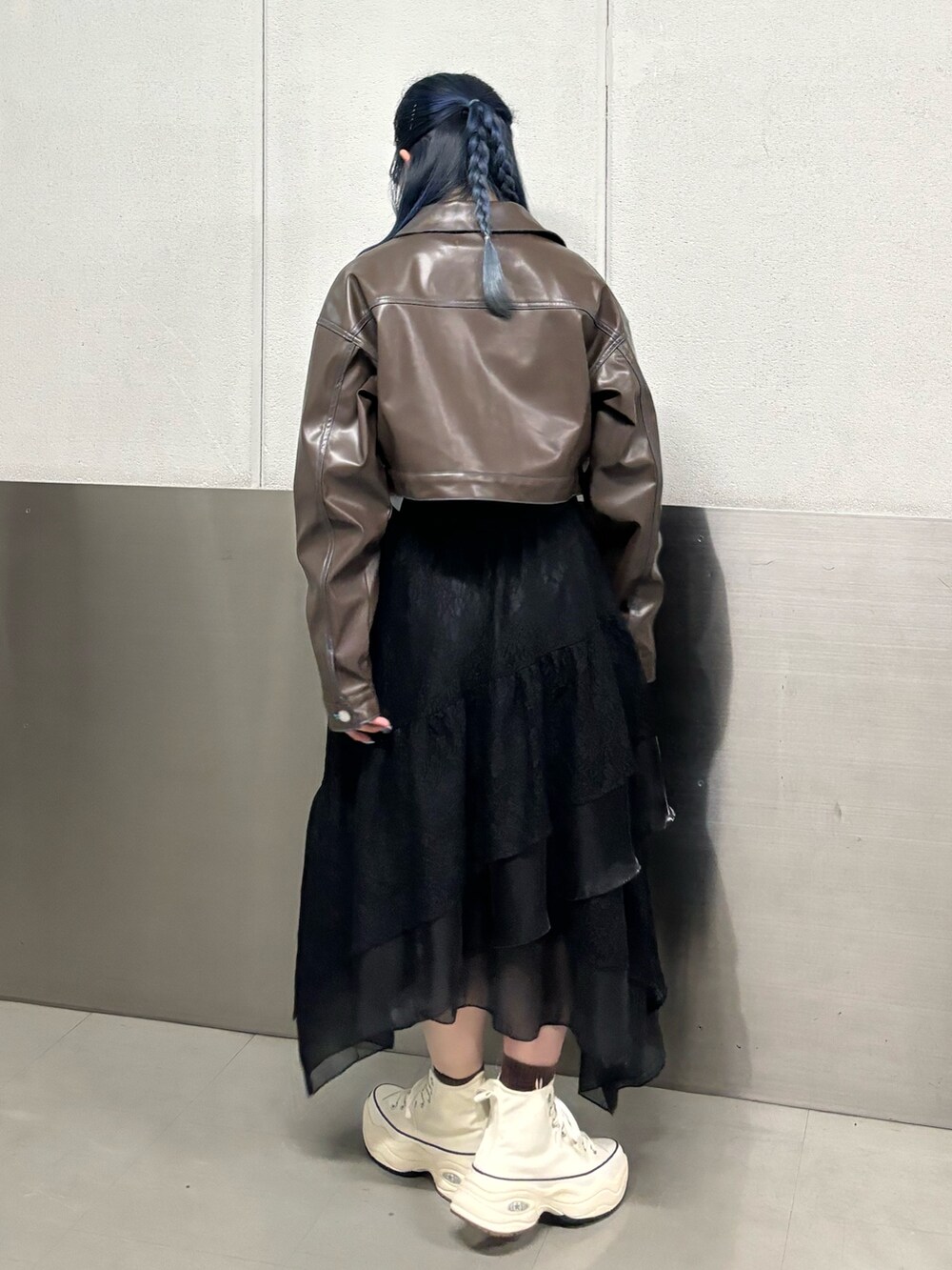 ブラック系のスカート、ホワイト系のスニーカー、ブルー系のTシャツ/カットソーを着用したレディースの冬コーディネートの3枚目の写真