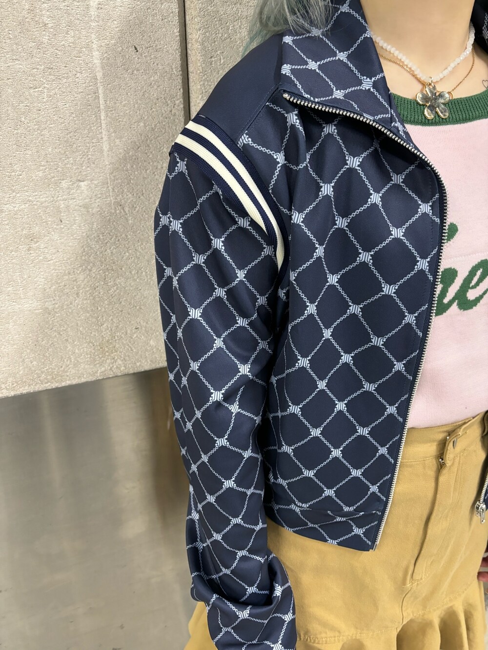 ベージュ系のスカート、ピンク系のニット/セーター、ブルー系のジャージを着用したレディースの春コーディネートの6枚目の写真