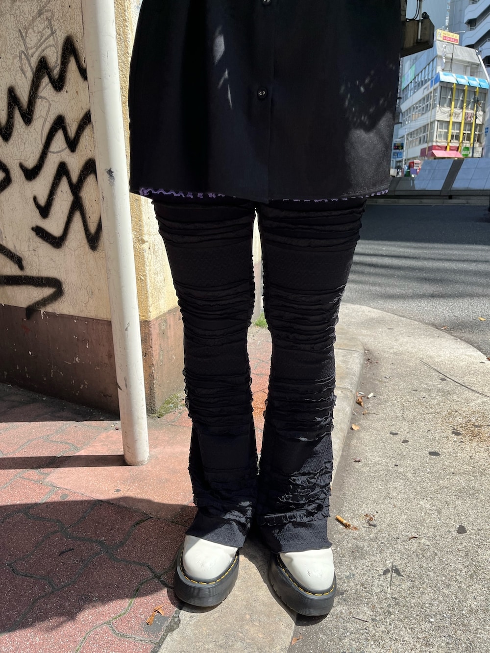 ブラック系のハンドバッグ、パープル系のTシャツ/カットソー、ブラック系のシャツ/ブラウスを着用したレディースの春コーディネートの6枚目の写真