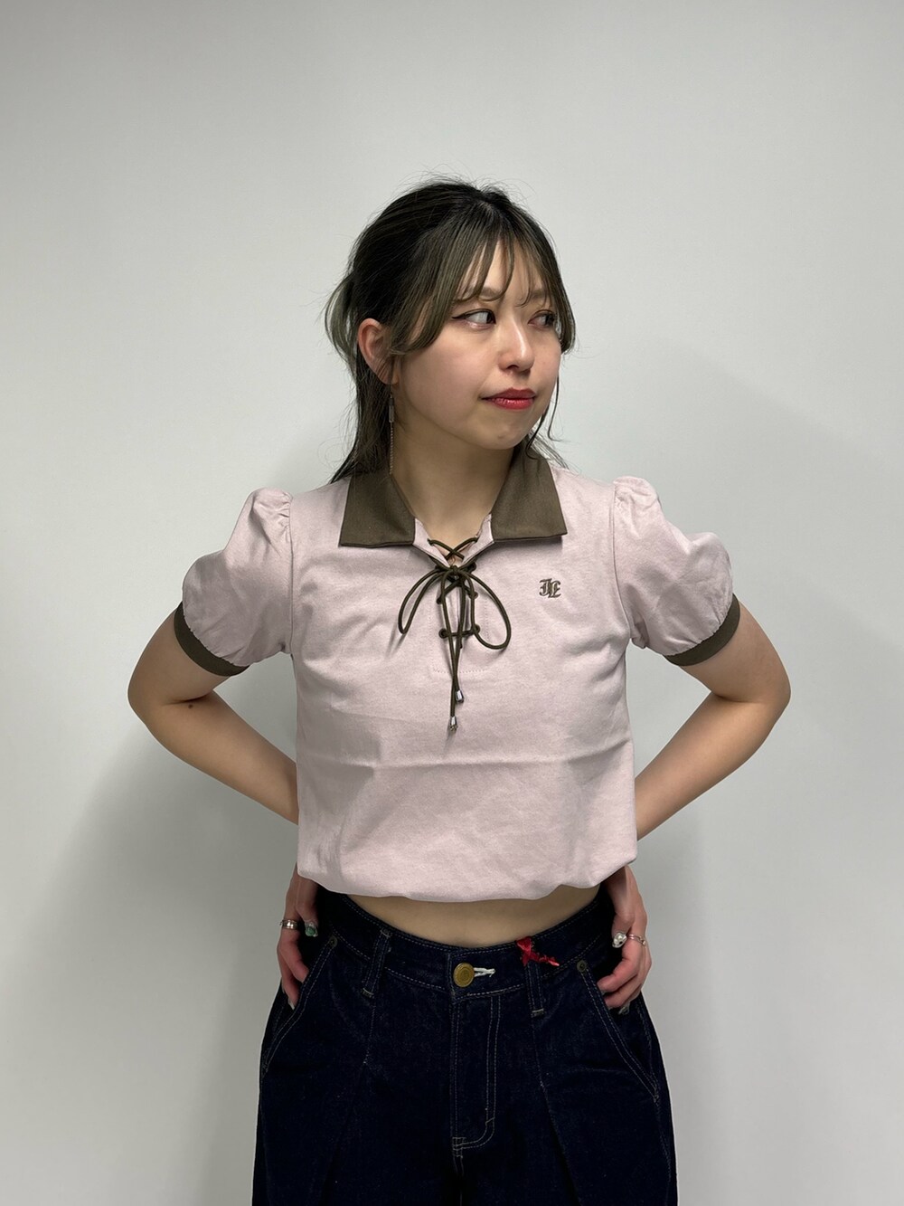 ブルー系のデニムパンツ、ピンク系のポロシャツを着用したレディースの春コーディネートの5枚目の写真