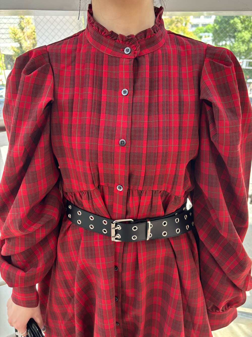 レッド系のワンピース、ブラック系のハンドバッグ、ブラック系のその他パンツを着用したレディースの秋コーディネートの6枚目の写真