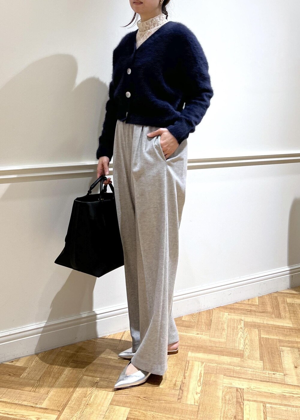 シルバー系のパンプス、ブラック系のトートバッグ、ブルー系のカーディガン/ボレロを着用したレディースの秋コーディネートの4枚目の写真