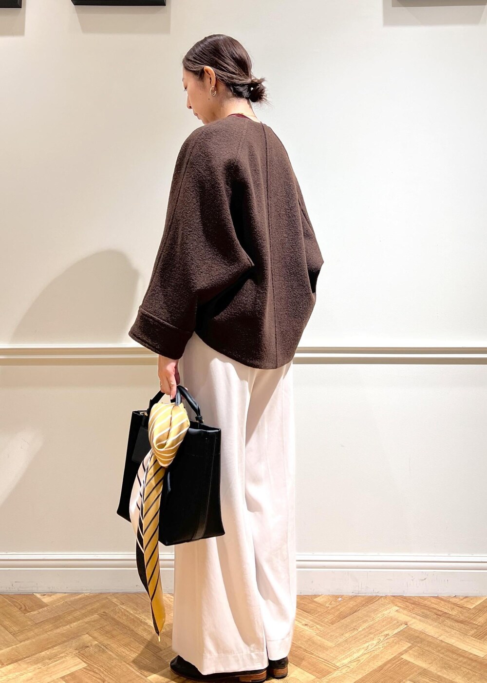 ベージュ系のその他パンツ、ブラウン系のブルゾン、レッド系のTシャツ/カットソーを着用したレディースの秋コーディネートの5枚目の写真