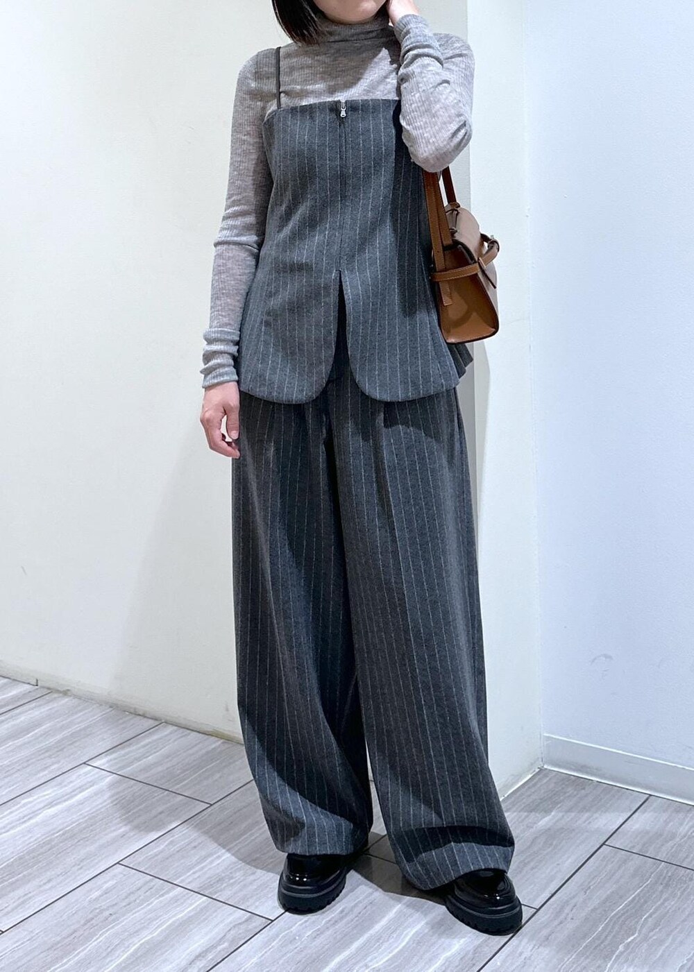 グレー系のキャミソール、グレー系のニット/セーター、グレー系のスラックスを着用したレディースの秋コーディネートの5枚目の写真