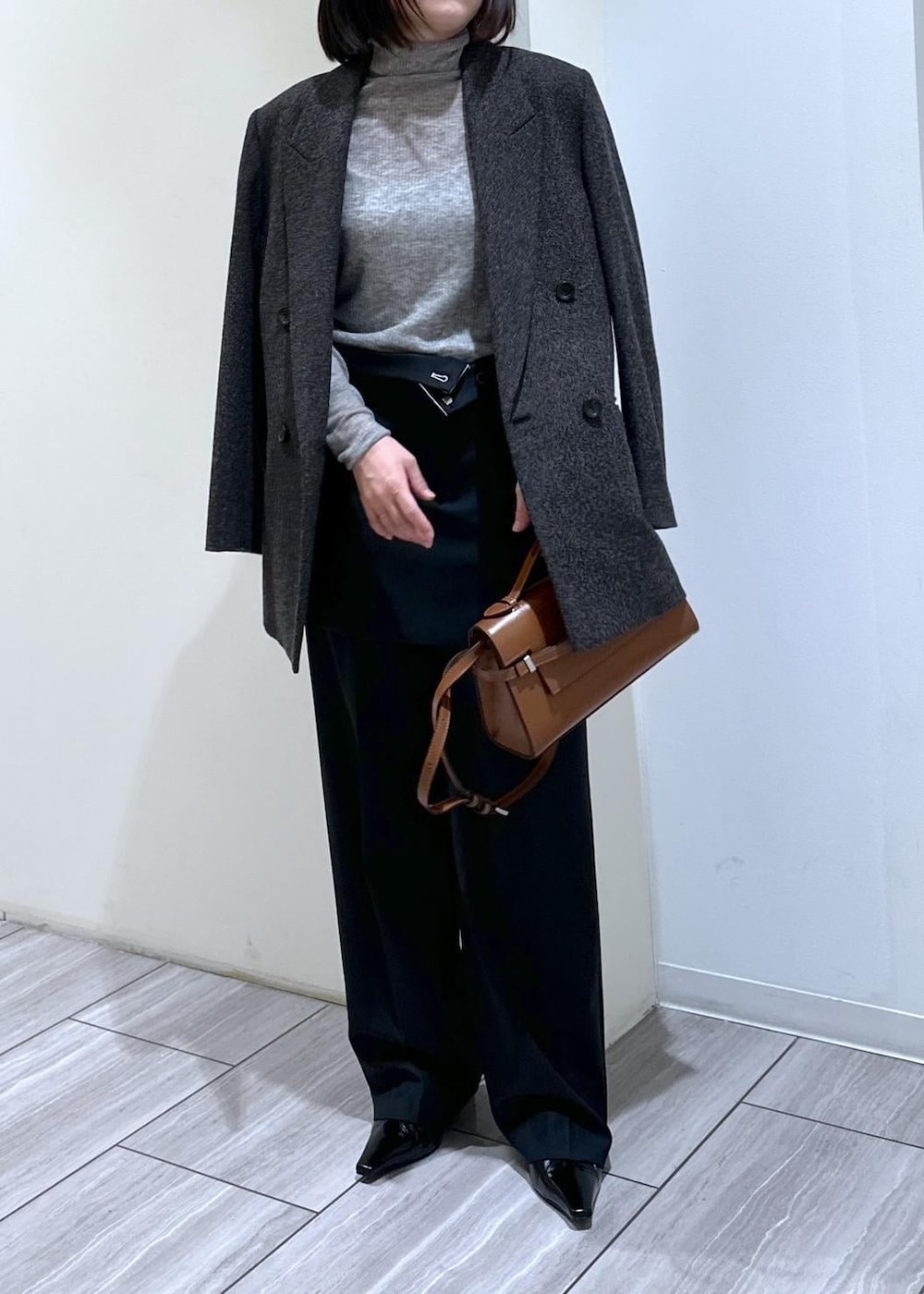 ブラック系のパンプス、グレー系のニット/セーター、ブラック系のスラックスを着用したレディースの秋コーディネートの6枚目の写真