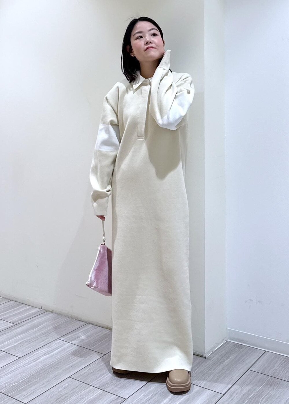 ベージュ系のブーツ、ホワイト系のブルゾン、ホワイト系のワンピースを着用したレディースの冬コーディネートの4枚目の写真