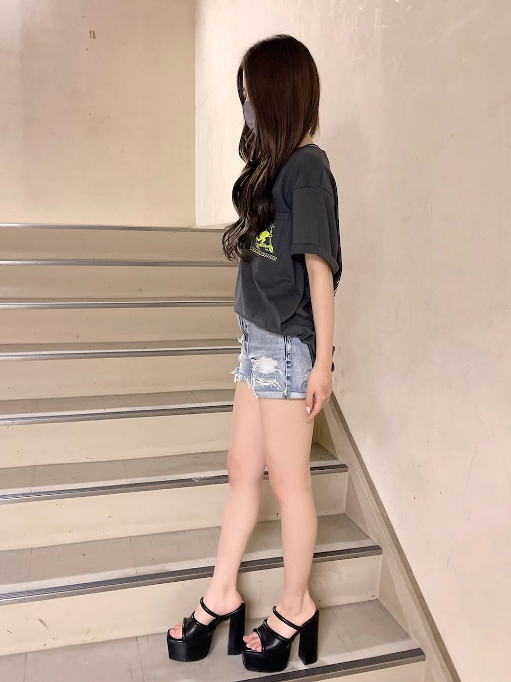 ブルー系のデニムパンツ、グレー系のTシャツ/カットソー、ブラック系のサンダルを着用したレディースの春コーディネートの2枚目の写真