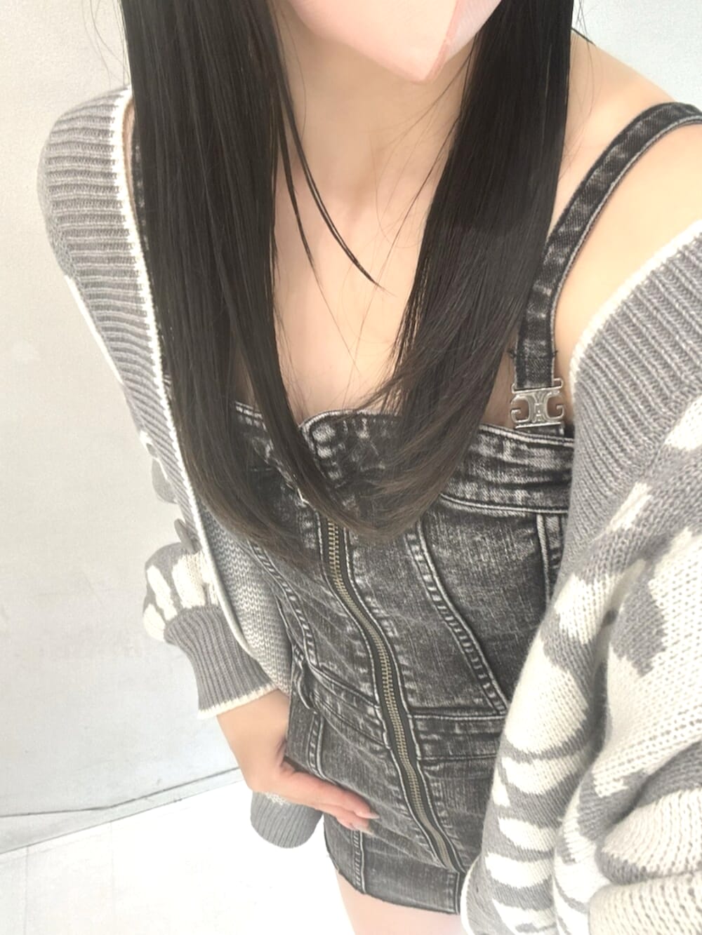 ブラック系のワンピース、グレー系のカーディガン/ボレロ、ホワイト系のサンダルを着用したレディースの春コーディネートの4枚目の写真