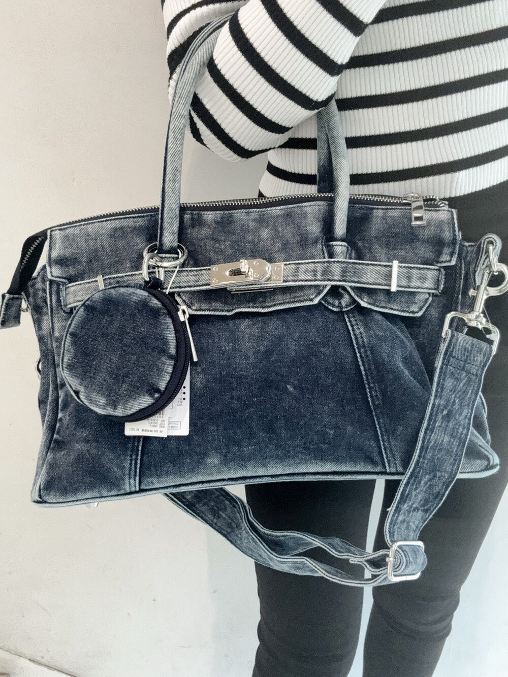 その他のニット/セーター、ブラック系のデニムパンツ、ブルー系のハンドバッグを着用したレディースの秋コーディネートの6枚目の写真