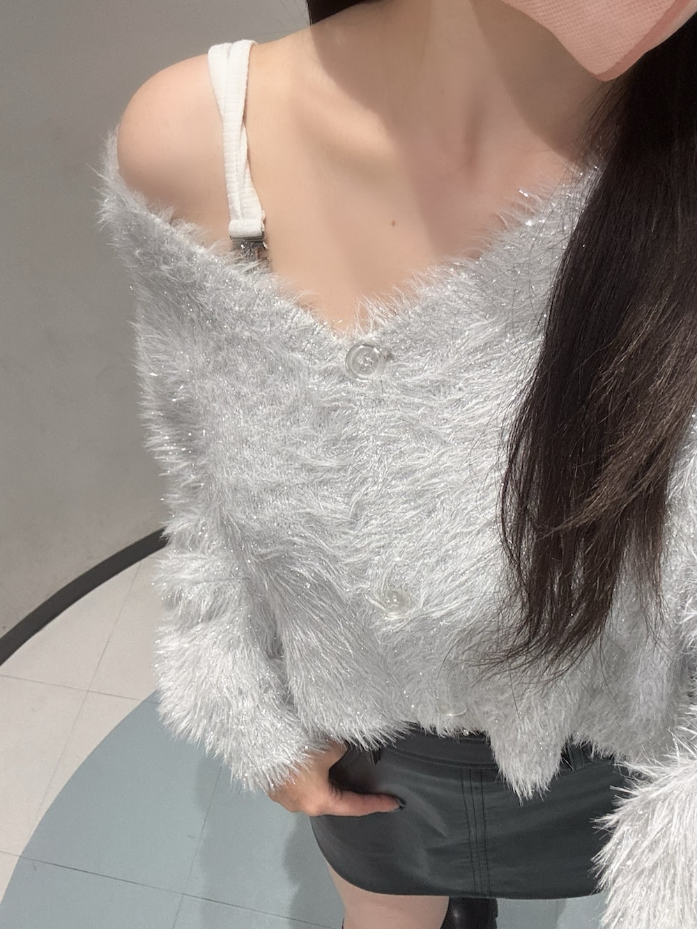 ホワイト系のカーディガン/ボレロ、ホワイト系のキャミソール、ブラック系のスカートを着用したレディースの秋コーディネートの4枚目の写真