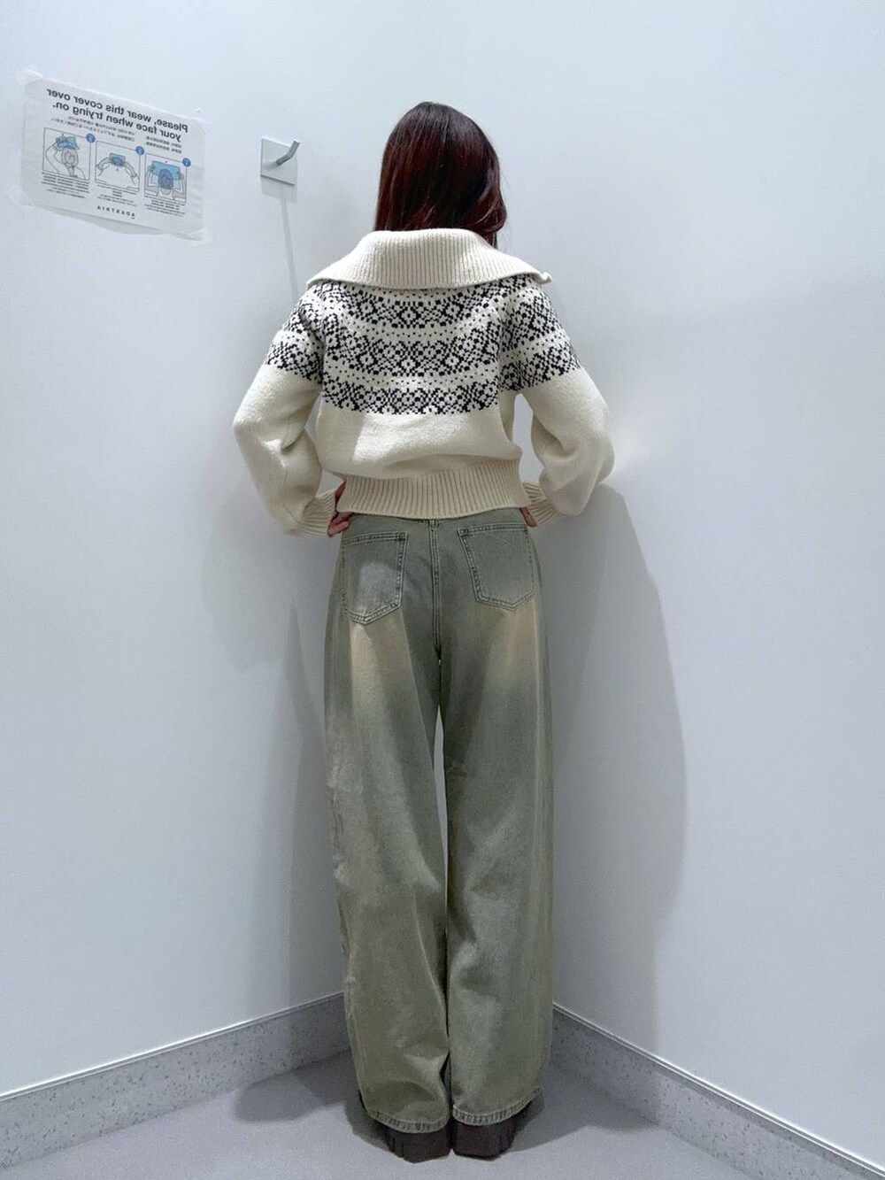 ブルー系のデニムパンツ、ブラウン系のブーツ、ベージュ系のニット/セーターを着用したレディースの冬コーディネートの3枚目の写真