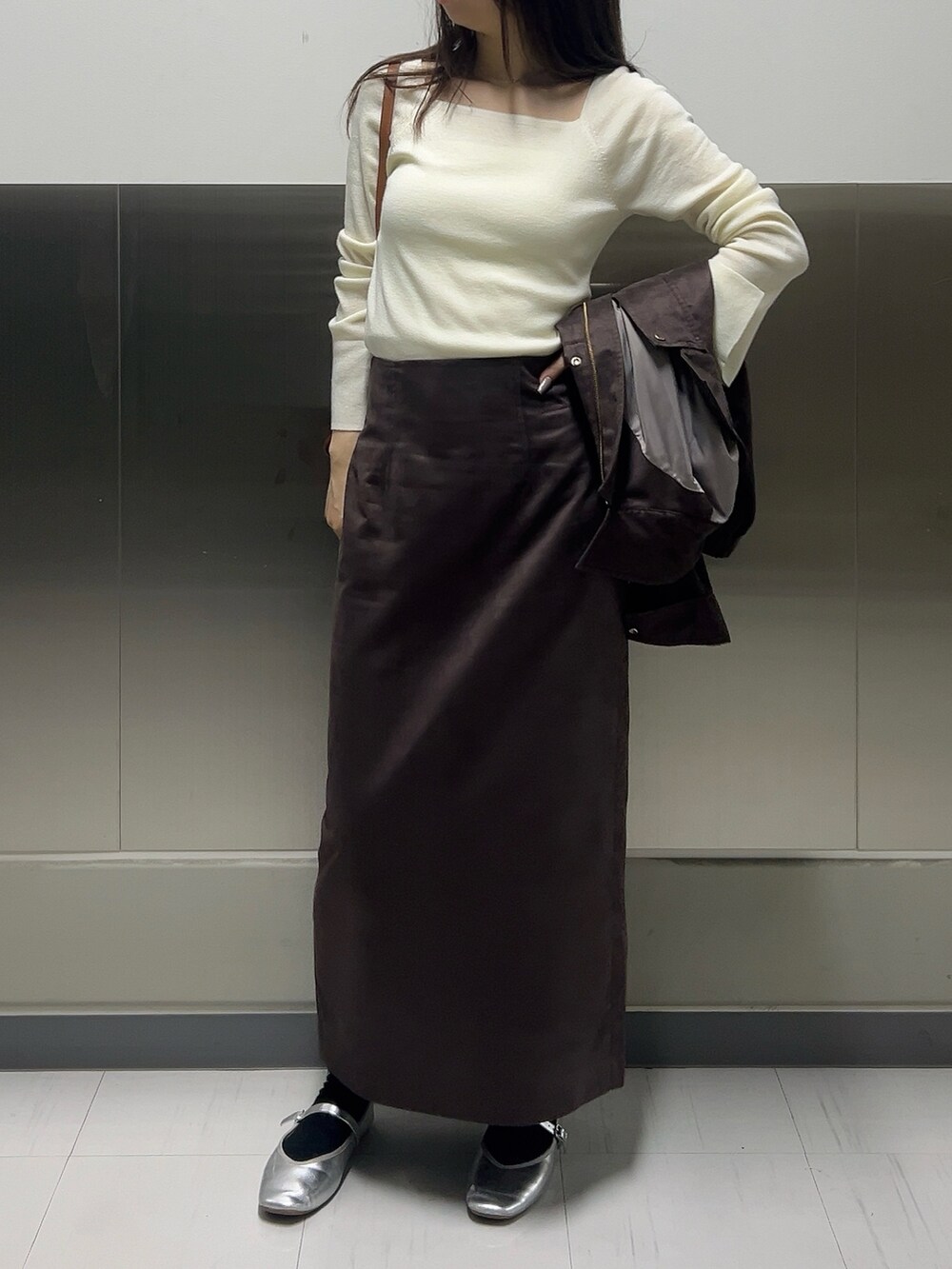 ブラウン系のブルゾン、ホワイト系のニット/セーター、ブラウン系のスカートを着用したレディースの秋コーディネートの10枚目の写真