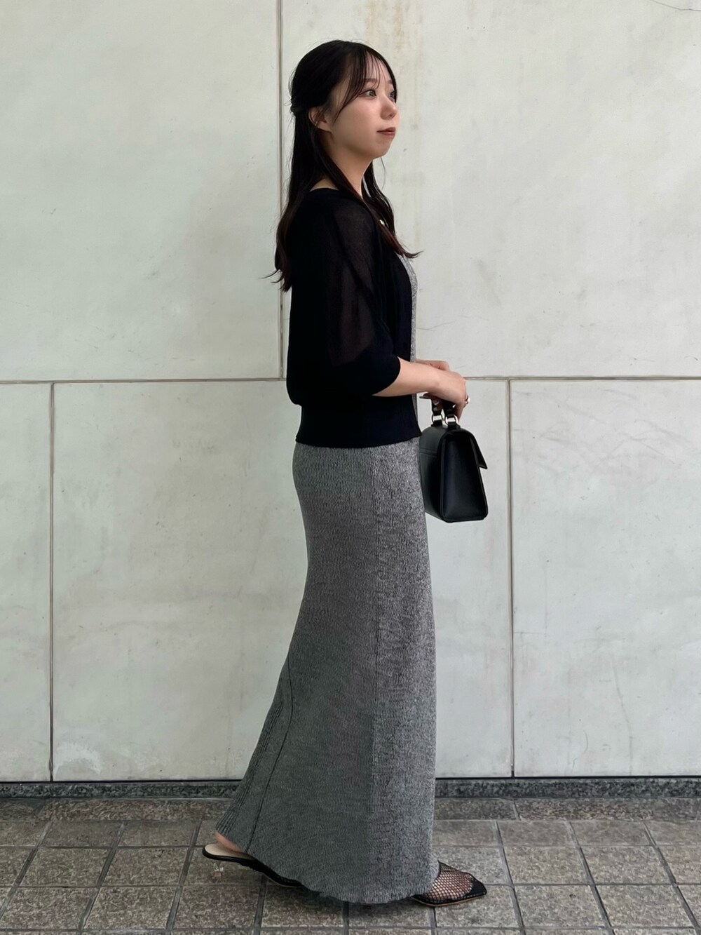 ブラック系のカーディガン/ボレロ、グレー系のワンピース、ブラック系のハンドバッグを着用したレディースの夏コーディネートの4枚目の写真