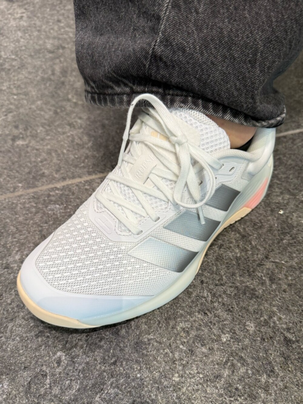 ホワイト系のトップス、ブラック系のトップス、ホワイト系のスニーカーを着用したレディースの冬コーディネートの4枚目の写真