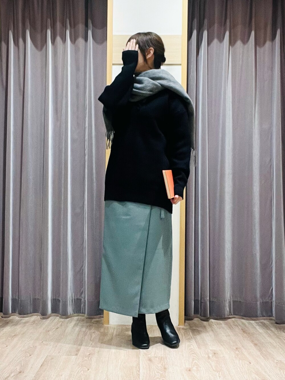 グリーン系のスカート、ブラック系のブーツ、グレー系のストール/ショールを着用したレディースの秋コーディネートの4枚目の写真