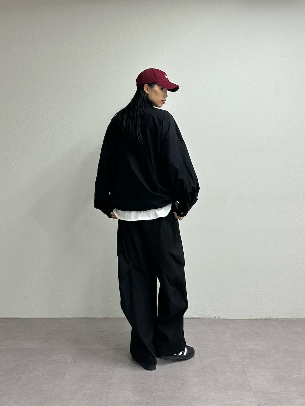 ブラック系のその他パンツ、ブラック系のブルゾン、ホワイト系のTシャツ/カットソーを着用したレディースの夏コーディネートの3枚目の写真