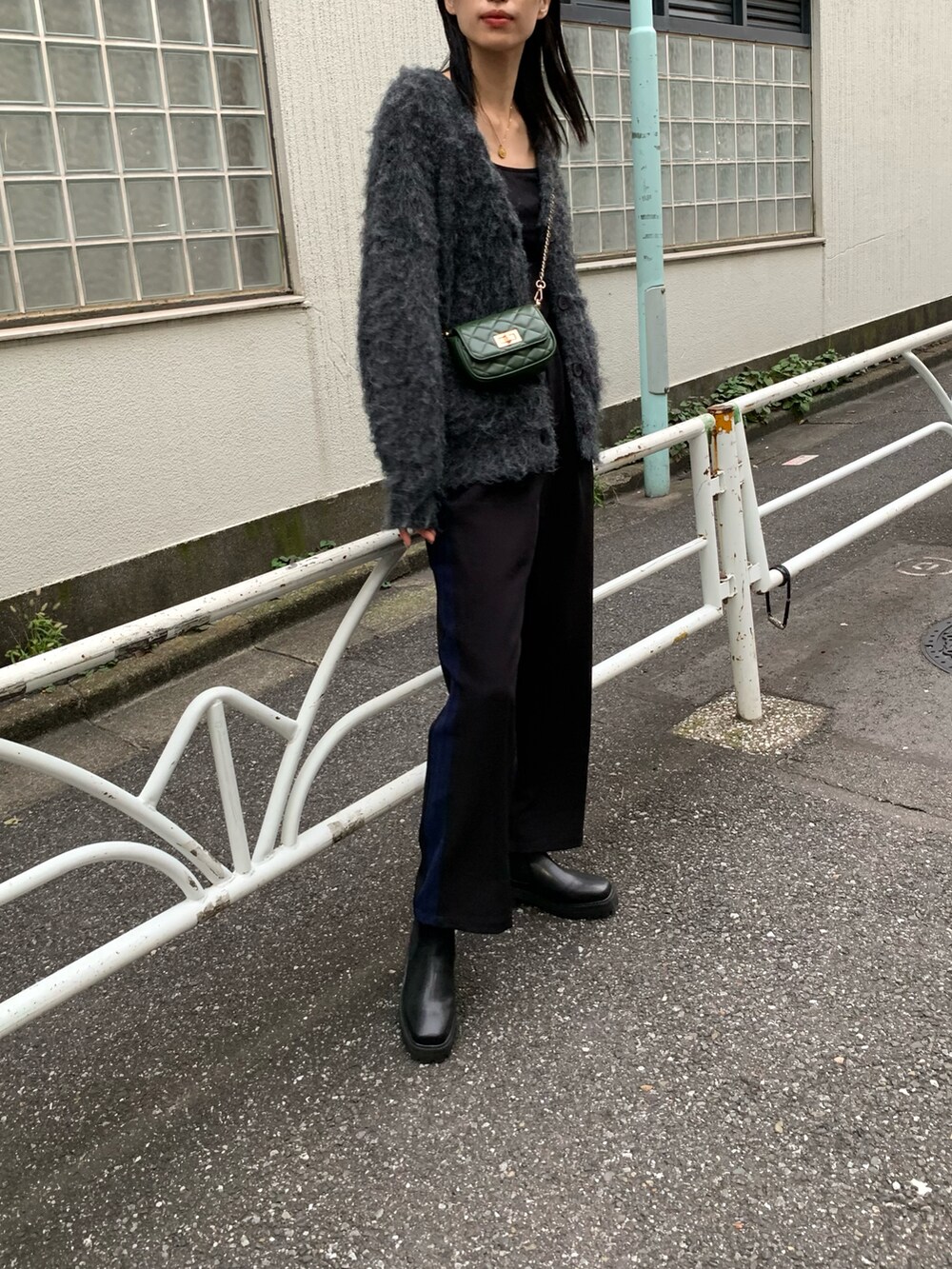 ブラック系のその他パンツ、グリーン系のショルダーバッグ、ブラック系のカーディガン/ボレロを着用したレディースの秋コーディネートの2枚目の写真