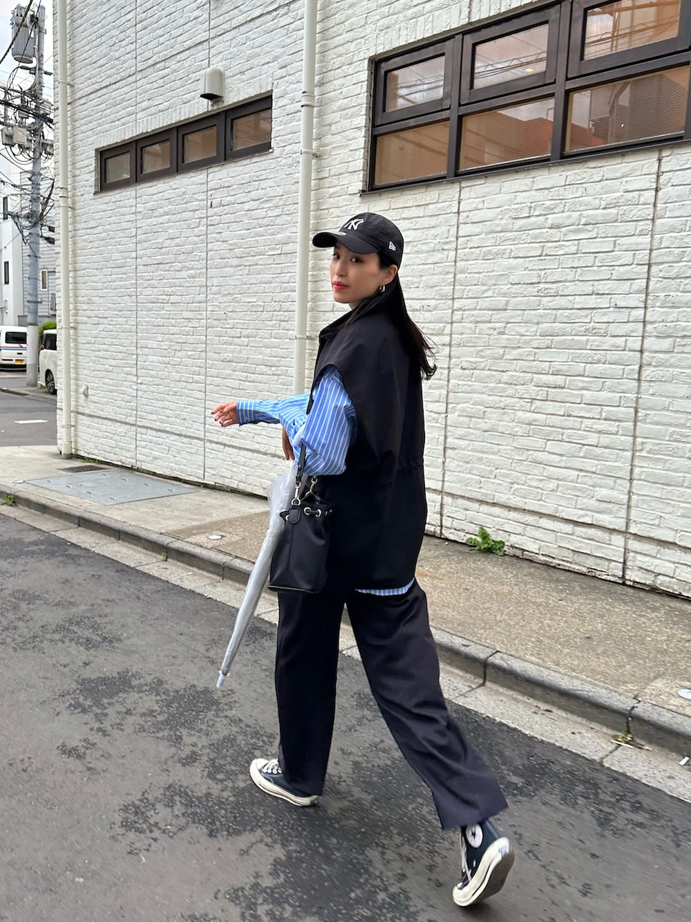 ブラック系のパンツ、ブラック系のスニーカー、ブルー系のシャツ/ブラウスを着用したレディースの春コーディネートの2枚目の写真