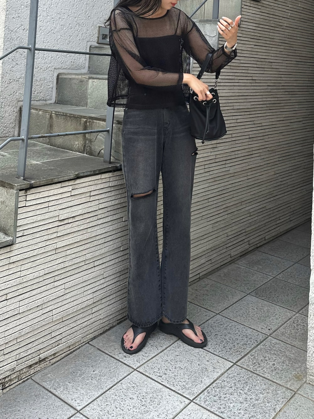 ブラック系のデニムパンツ、ブラック系のTシャツ/カットソーを着用したレディースの春コーディネートの2枚目の写真