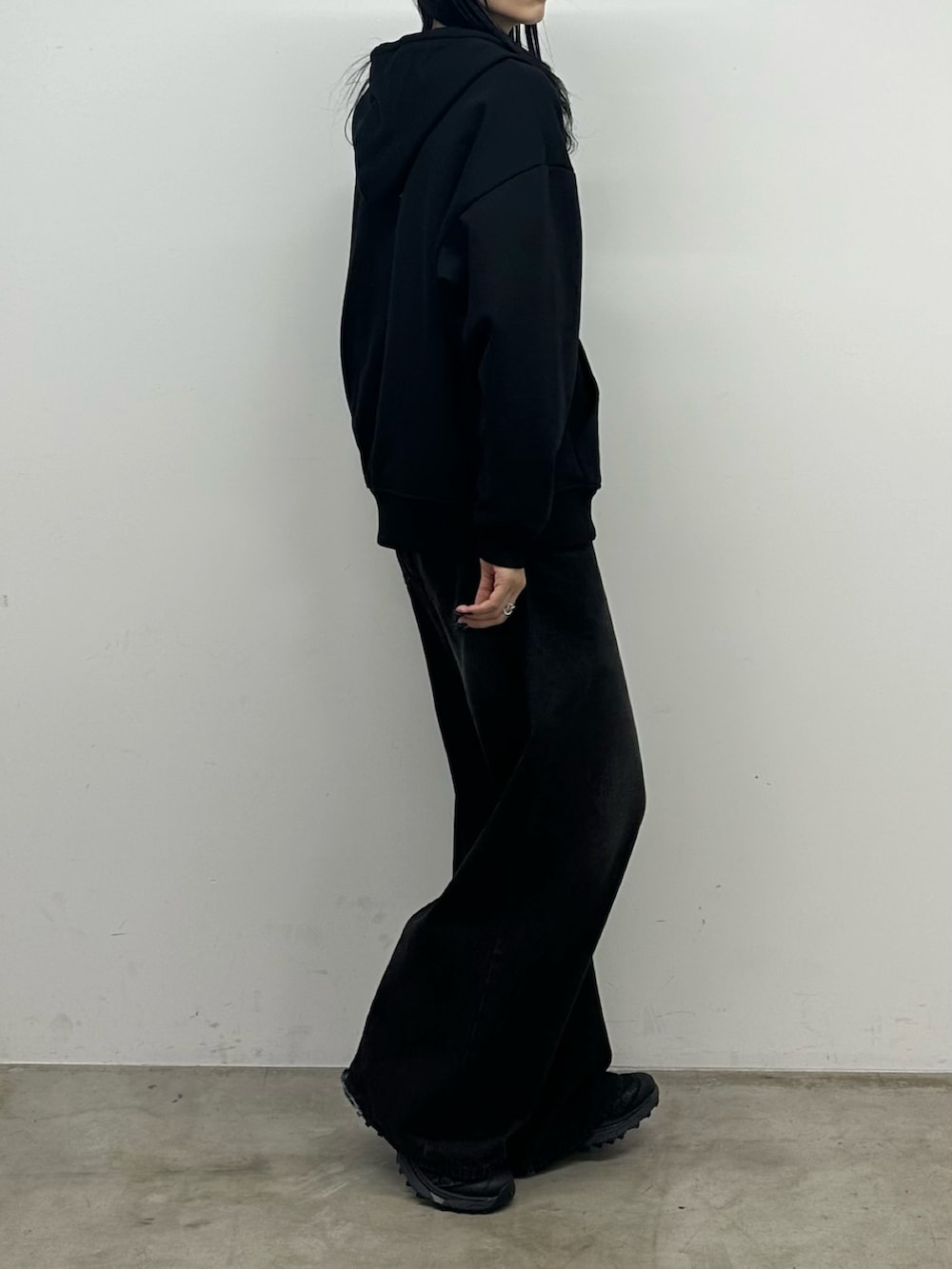 ブラック系のデニムパンツ、ブラック系のパーカーを着用したレディースの秋コーディネートの3枚目の写真