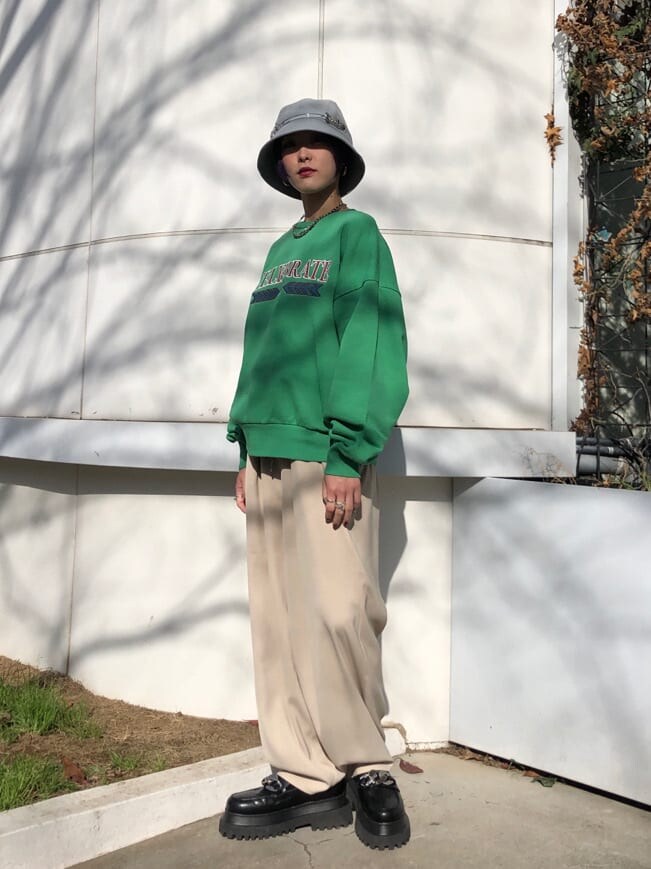 ホワイト系のスラックス、グリーン系のスウェットを着用したレディースの冬コーディネートの3枚目の写真