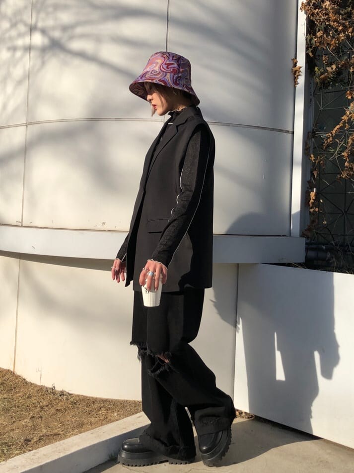 ブラック系のベスト、ブラック系のデニムパンツ、ブラック系のTシャツ/カットソーを着用したレディースの春コーディネートの3枚目の写真