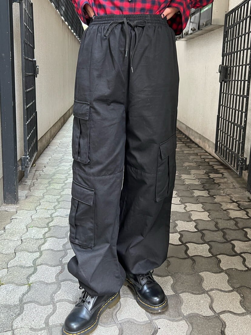 ブラック系のバックパック/リュック、レッド系のシャツ/ブラウス、ブラック系のカーゴパンツを着用したレディースの秋コーディネートの8枚目の写真