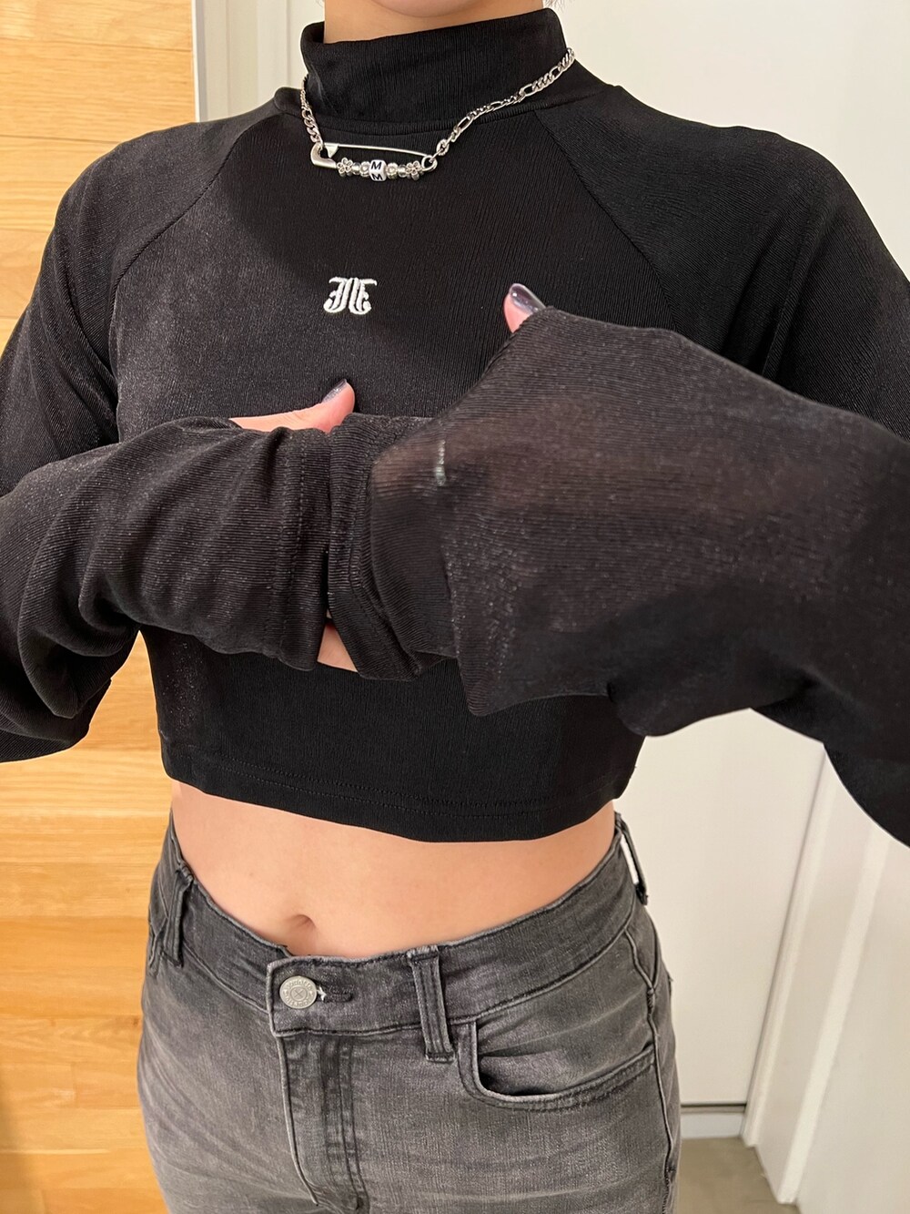 ブラック系のデニムパンツ、ブラック系のTシャツ/カットソー、ベージュ系のワンピースを着用したレディースの秋コーディネートの9枚目の写真