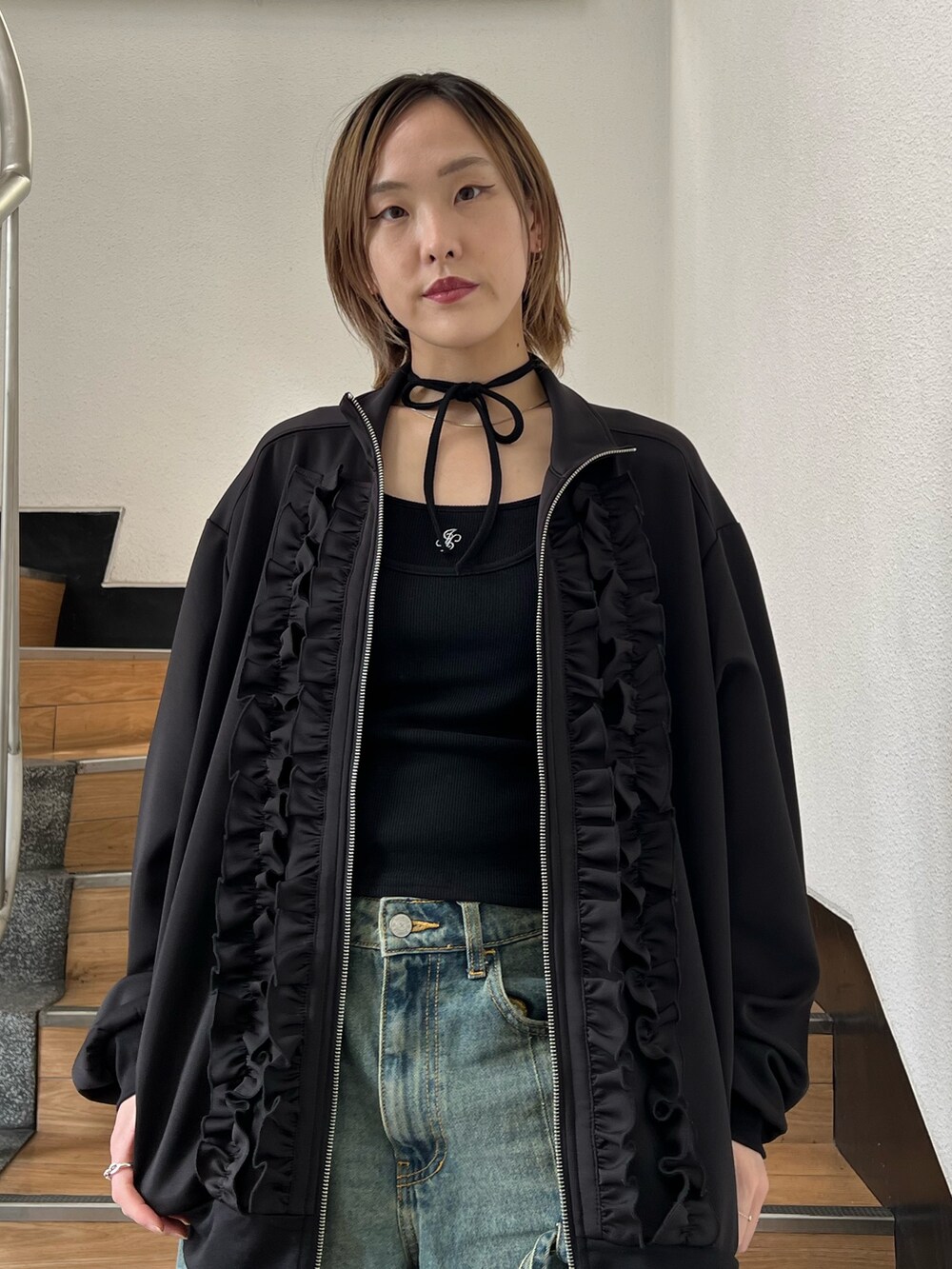 ブラック系のジャージ、ブラック系のキャミソールを着用したレディースの春コーディネートの7枚目の写真