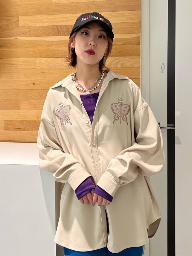 ブラック系のブーツ、ホワイト系のシャツ/ブラウス、パープル系のTシャツ/カットソーを着用したレディースの秋コーディネートの6枚目の写真