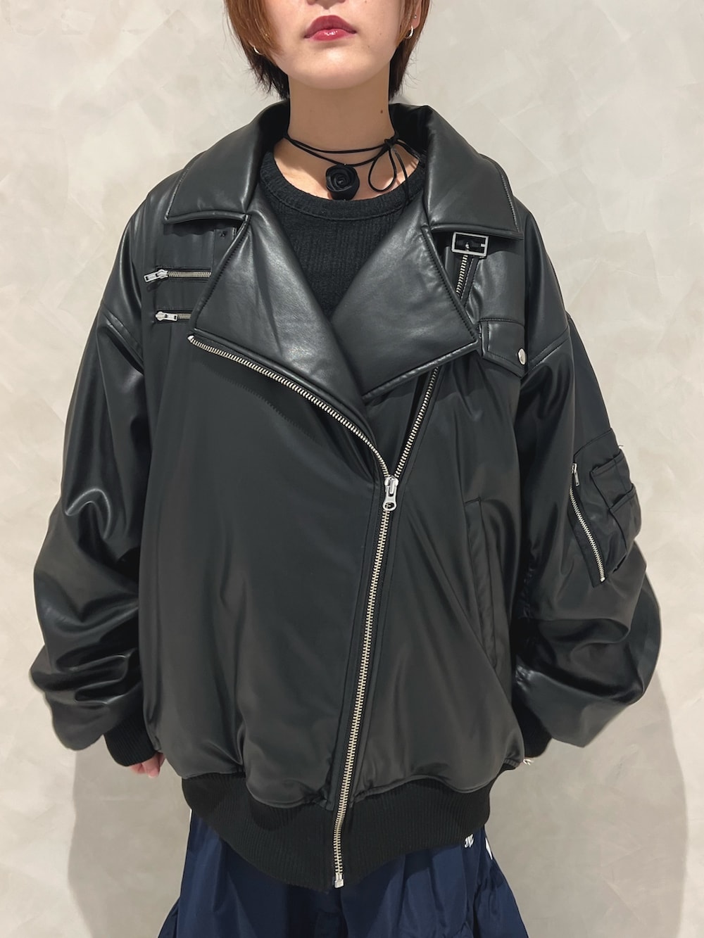 ブラック系のブルゾン、ブルー系のスカート、ブラック系のブーツを着用したレディースの秋コーディネートの5枚目の写真