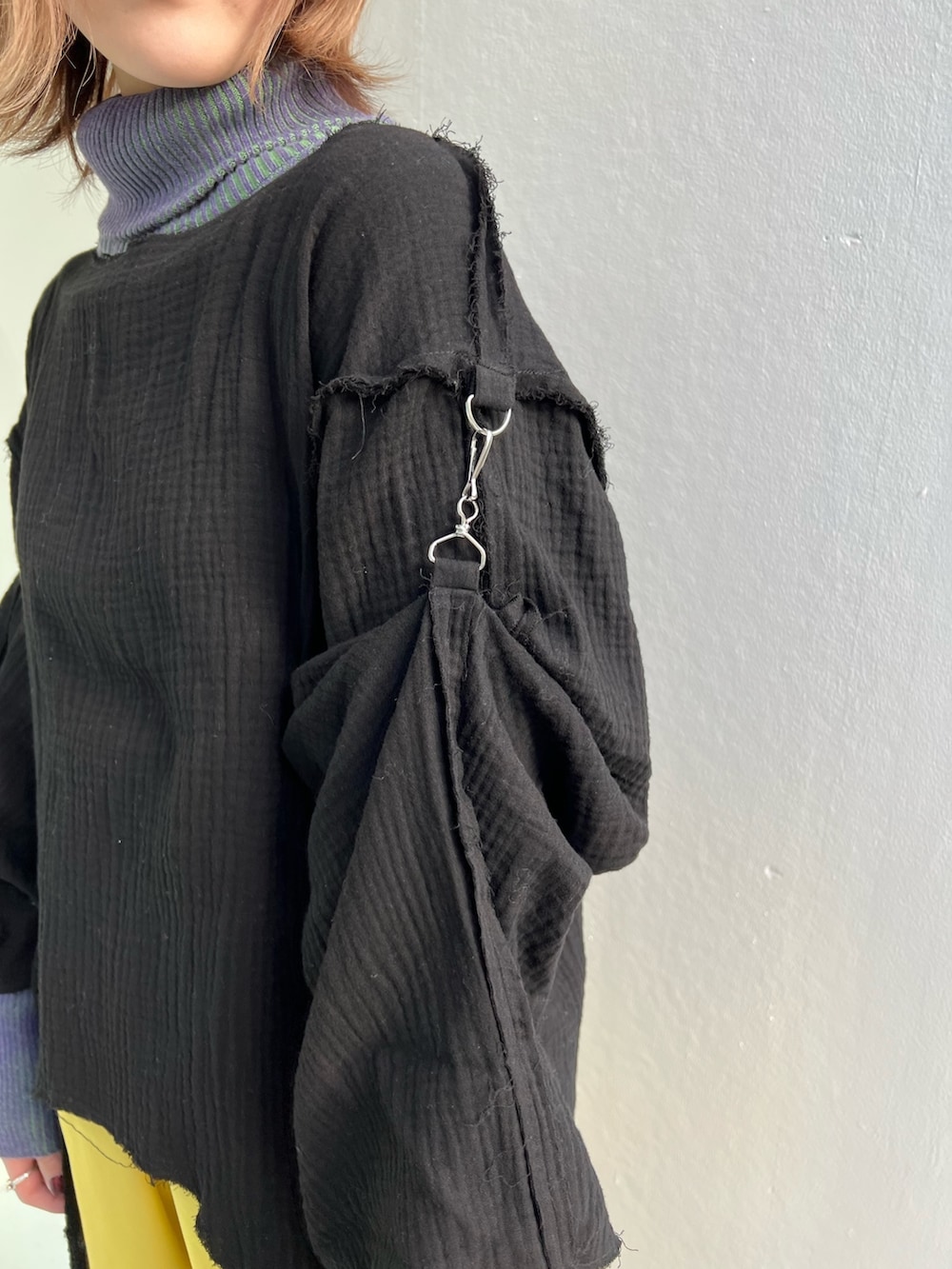 イエロー系のその他パンツ、パープル系のニット/セーター、ブラック系のシャツ/ブラウスを着用したレディースの冬コーディネートの6枚目の写真