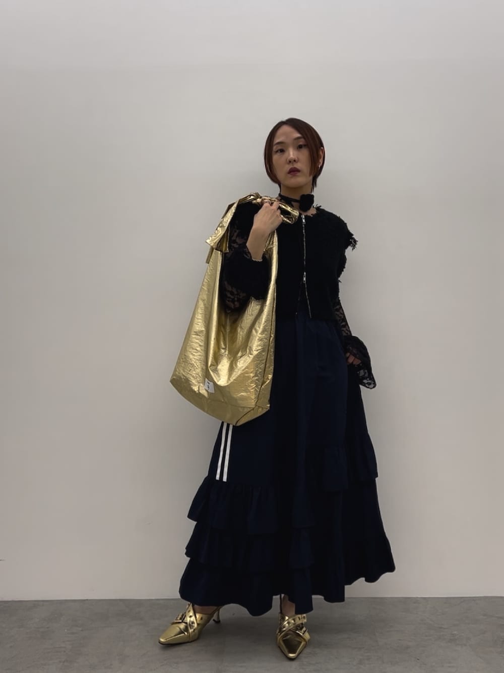 ブラック系のベスト、ブラック系のTシャツ/カットソー、ゴールド系のパンプスを着用したレディースの夏コーディネートの2枚目の写真