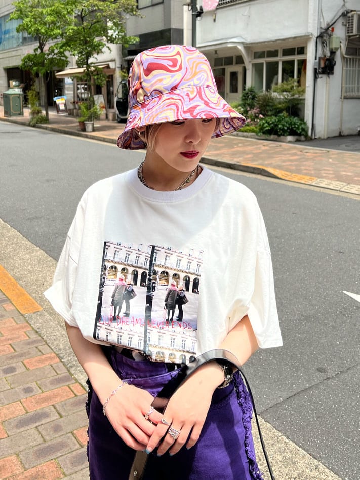 ブラック系のハンドバッグ、ホワイト系のTシャツ/カットソー、パープル系のデニムパンツを着用したレディースの夏コーディネートの4枚目の写真