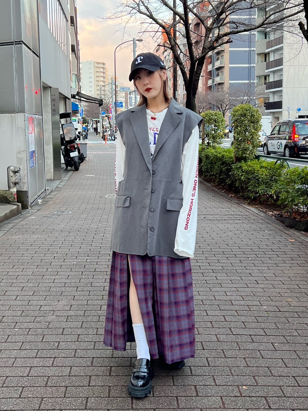 ブルー系のスカート、ホワイト系のTシャツ/カットソー、グレー系のベストを着用したレディースの春コーディネートの4枚目の写真