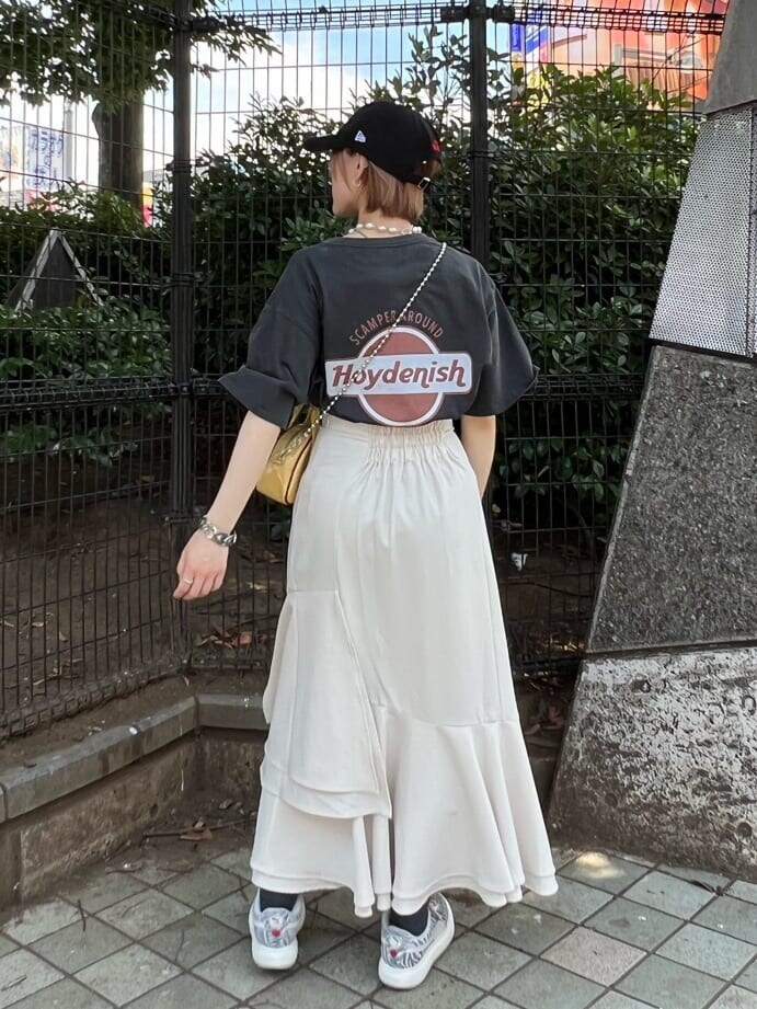 ホワイト系のスカート、イエロー系のボストンバッグ、ブラック系のTシャツ/カットソーを着用したレディースの夏コーディネートの3枚目の写真