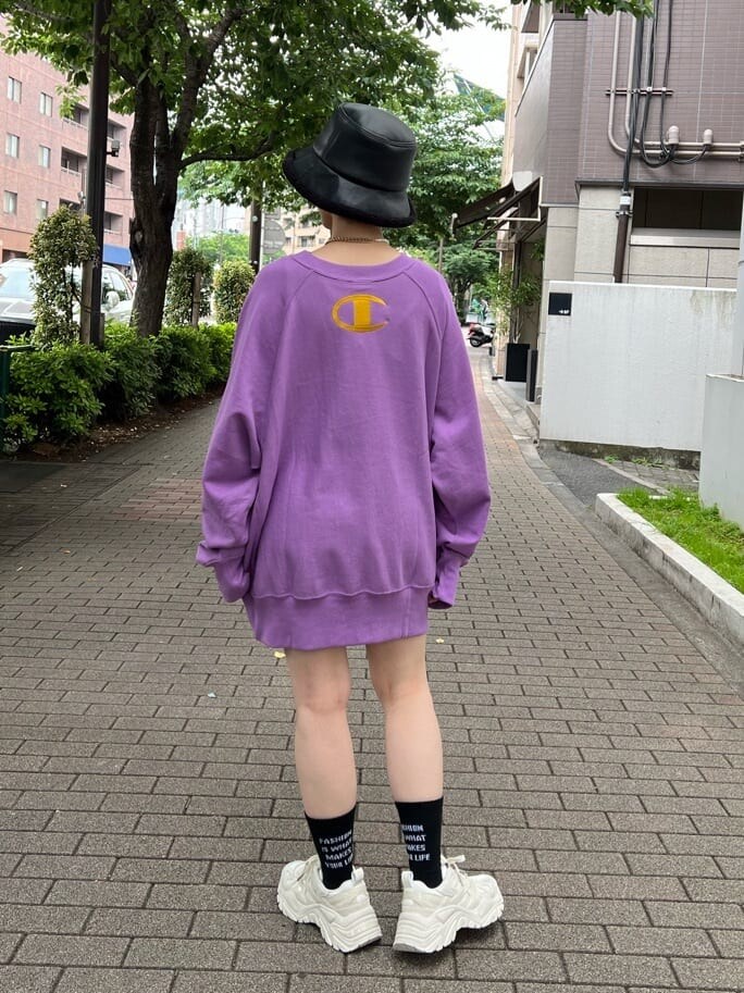 ブラック系のデニムパンツ、ホワイト系のスニーカー、パープル系のスウェットを着用したレディースの夏コーディネートの4枚目の写真